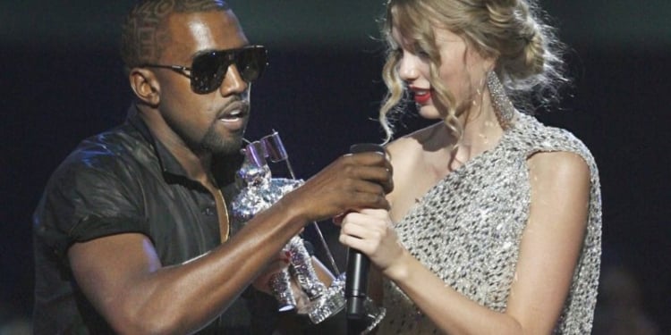 Singer Kanye West takes the microphone from singer Taylor Swift as she accepts the "Best Female Video" award during the MTV Video Music Awards on Sunday, Sept. 13, 2009 in New York.  (AP Photo/Jason DeCrow)