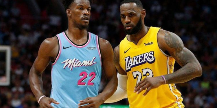 MIAMI, FLORIDA - DECEMBER 13:  LeBron James #23 of the Los Angeles Lakers guards Jimmy Butler #22 of the Miami Heat during the second half at American Airlines Arena on December 13, 2019 in Miami, Florida. NOTE TO USER: User expressly acknowledges and agrees that, by downloading and/or using this photograph, user is consenting to the terms and conditions of the Getty Images License Agreement (Photo by Michael Reaves/Getty Images)