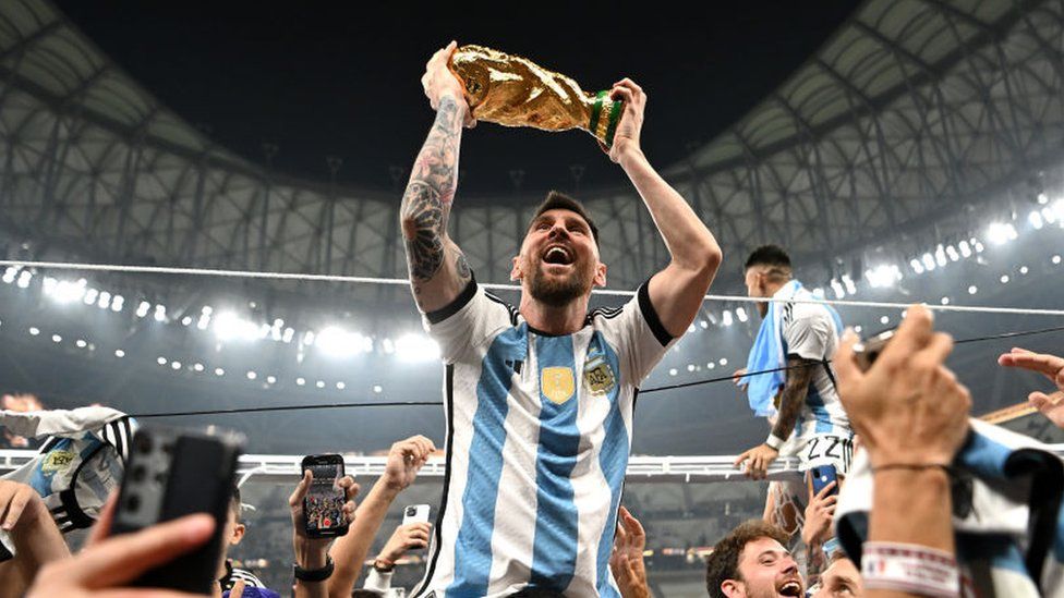 Messi celebrates with the World Cup trophy IMAGE SOURCE,GETTY IMAGES
